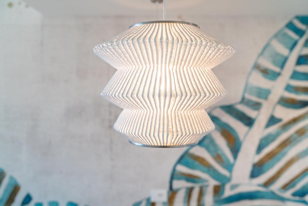 The One Caorle - Hotel & Apartments Esterno foto A pendant light